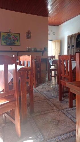 a dining room with wooden tables and chairs at Pousada Santo Expedito in Tiradentes