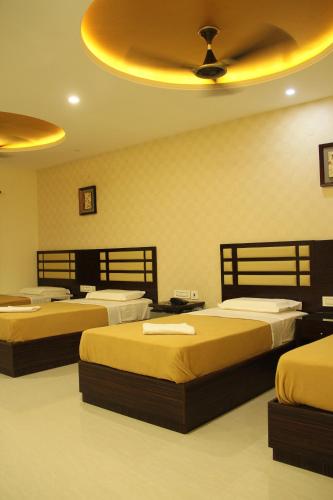 Postel nebo postele na pokoji v ubytování Hotel M.P Temples Inn