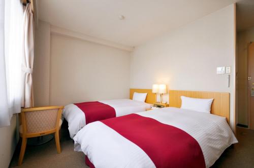Postel nebo postele na pokoji v ubytování Annex Hotel Abe