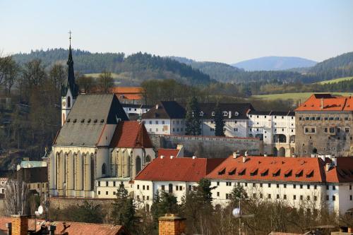 a large white building with red roofs in a town at Penzion Krumlov - Massage studio in Český Krumlov