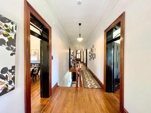 a hallway of a home with wooden floors and large windows at Linden Lodge in Linden