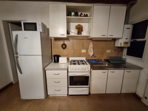 a kitchen with white appliances and a white refrigerator at Pindó I in Concordia
