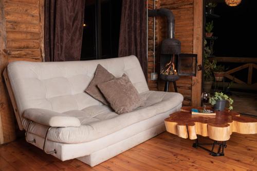 a white couch in a living room with a fireplace at Mi lugar secreto in Medellín