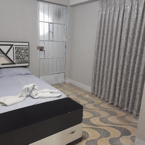 um quarto com uma cama e uma cortina de chuveiro em Travel house ica em Ica