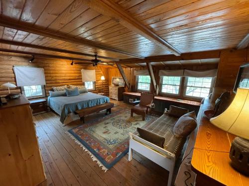 a bedroom with a bed and a couch in a room at Doe Creek Horse Ranch in Bandera