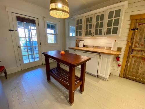 a kitchen with a wooden table in a room at Family Summer House in the Eastern Townships in Ayer's Cliff