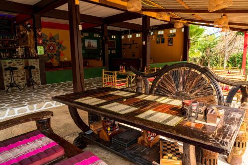 a table and chairs in a room with a wheel at Wild Hippie Chang in Ban Nong Si Chaeng