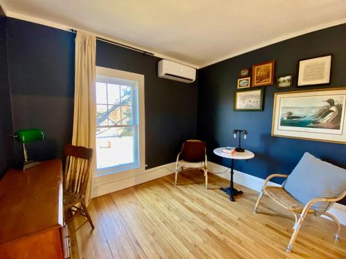 a room with a table and chairs and a window at Family Summer House in the Eastern Townships in Ayer's Cliff