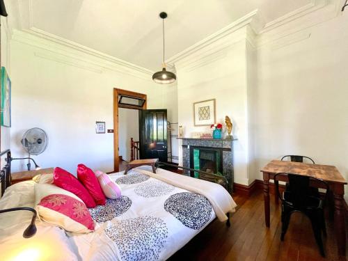 a bedroom with two beds and a fireplace at Linden Lodge in Linden