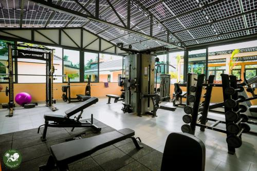 a gym with treadmills and machines in a room at LAM BUNGALOW Resort & Spa in Phu Quoc