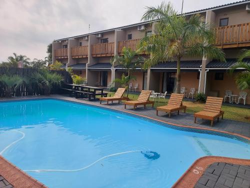 a large swimming pool in front of a hotel at St Lucia Lodge in St Lucia