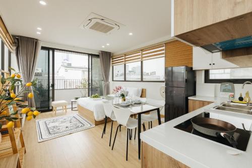 a kitchen and dining room with a table and chairs at Myrcella Urban Studio in Hanoi