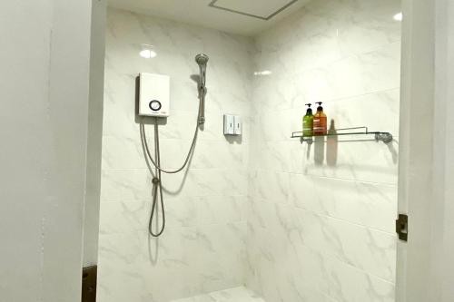 La salle de bains est pourvue d'une douche avec un pommeau de douche. dans l'établissement Forgotten Hostel Silom, à Bang Rak
