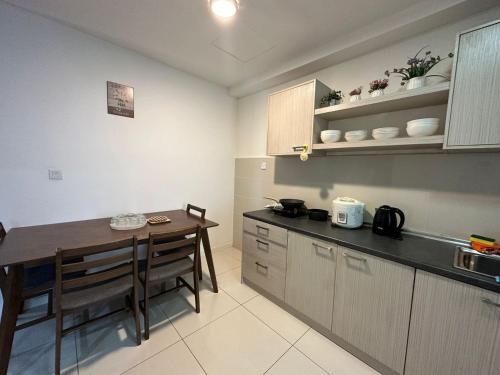 a kitchen with a table and a dining room at SA Sutera Avenue Homestay Opposite Imago KK in Kota Kinabalu