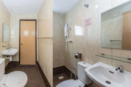 a bathroom with a toilet and a sink at Hash House Hotel in Melaka