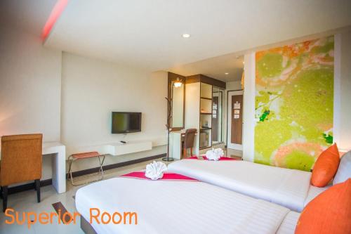 Ένα ή περισσότερα κρεβάτια σε δωμάτιο στο Ayara Grand Palace Hotel