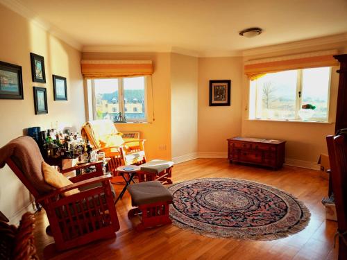 a living room with wooden floors and a large window at Best Location in Tralee in Tralee