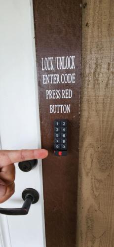 a person pointing to a door with a sign on it at #5 New! Cozy Getaway Hot Spot Hilo Keaau Big Island of Hawaii Self CheckIn Studio Apt in Keaau