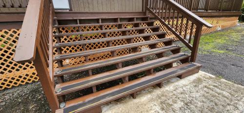 a set of wooden stairs next to a fence at #5 New! Cozy Getaway Hot Spot Hilo Keaau Big Island of Hawaii Self CheckIn Studio Apt in Keaau