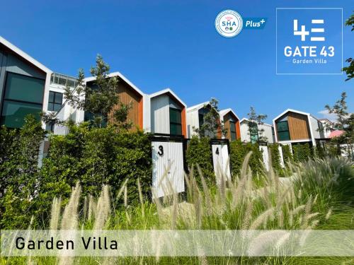 Gate43 Garden Villa في بانكوك: صف من البيوت امام ميدان عشب طويل