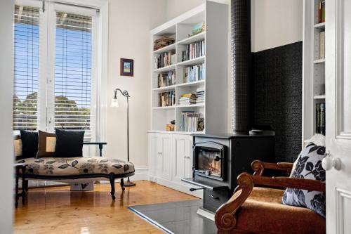 a living room with a fireplace and a couch at Dairy House- an idyllic country escape, Daylesford in Daylesford