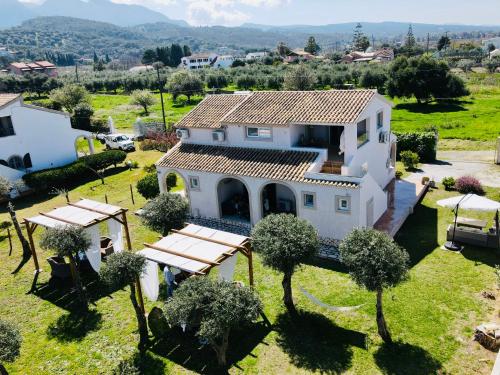 an aerial view of a white house with trees at Sirios in Acharavi