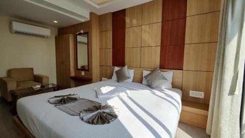 a bedroom with a bed with two towels on it at Hotel Ridley International in Digha