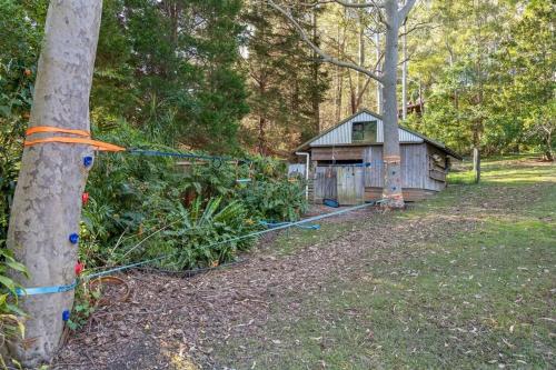 a tree with an orange tape wrapped around a house at Moroccan Acreage -Heated Pool w Slide -PlayBarn in Holgate