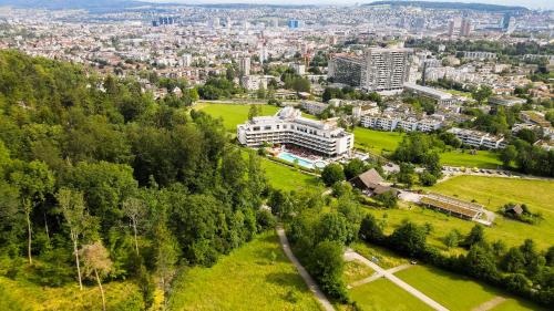 an aerial view of a city with buildings and trees at FIVE Zurich - Luxury City Resort in Zürich