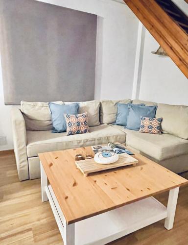 a living room with a couch and a coffee table at J&B Maisonette House in Marmarion