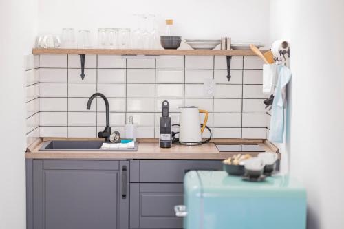 a kitchen with a sink and a counter top at Babyky apartmány in Jindrichuv Hradec