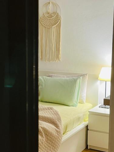 a bedroom with a bed with a green pillow at J&B Maisonette House in Marmarion