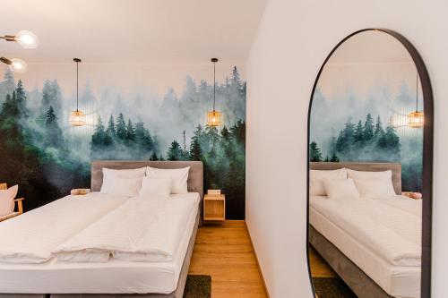 two beds in a room with a mirror at H11 ROOMS ESZTERGOM in Esztergom