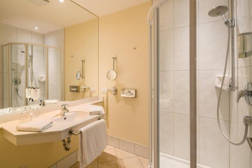 a bathroom with a sink and a shower at Castello Apartments in Lüneburg