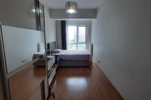 a bedroom with a bed and a desk and a mirror at Amazing view Large 1 bed 1 bath lovely apartment in Esenyurt