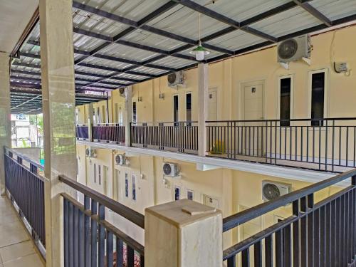 a hallway of a building with balconies at RedDoorz @ Al Muhajir Homestay Kendari in Kendari