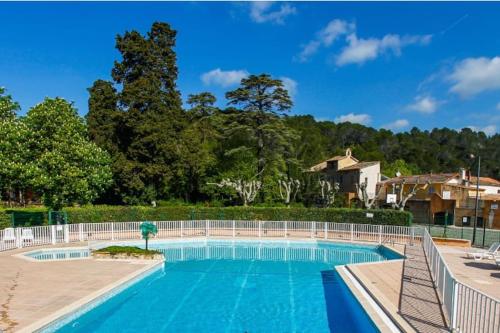 a swimming pool with a fence around it at Le Domaine du Thronnet in Figanières