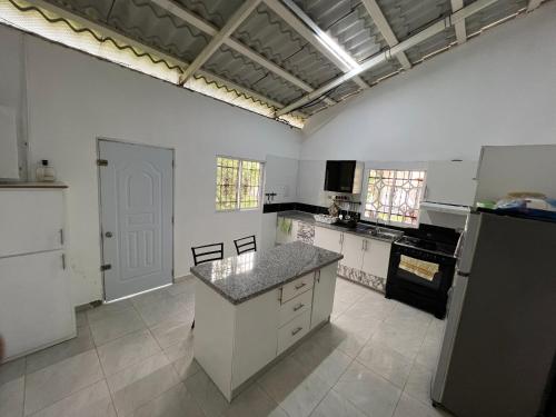 a large kitchen with white cabinets and a counter top at Villa Piña Alojamiento rural in San Rafael