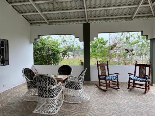 a patio with four chairs and a table at Villa Piña Alojamiento rural in San Rafael