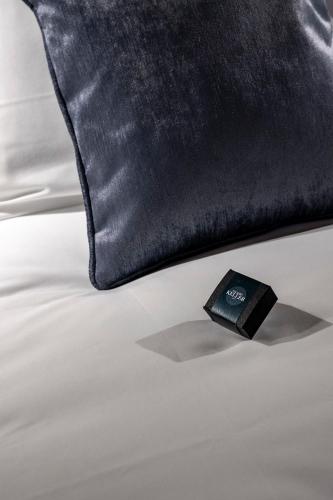 a black pillow sitting on top of a bed at Palazzo Keller in Venice