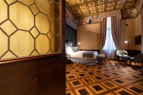 a hotel room with a bed and a window at Palazzo Keller in Venice