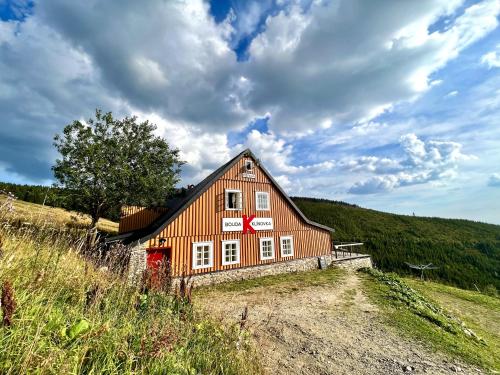 a barn on the side of a hill at Bouda Klínovka in Špindlerův Mlýn