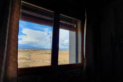 a window with a view of a desert view at Cal Curpets - Bicicletas FREE in Puigvert de Agramunt