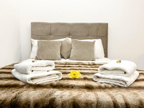 a bedroom with a bed with towels on it at LanaMarija Apartment in Trebinje