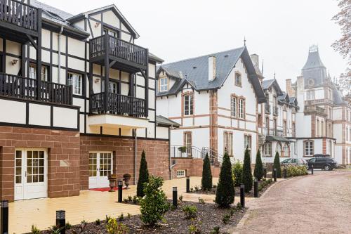 a row of buildings with trees in a courtyard at Château de Pourtalès in Strasbourg