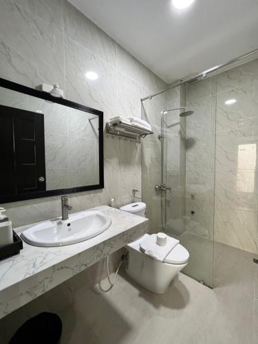 a bathroom with a sink and a toilet and a shower at May Studio in Da Lat