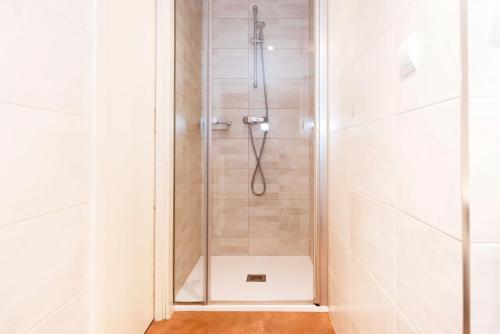 a shower with a glass door in a bathroom at Hotel Sauce in Zaragoza