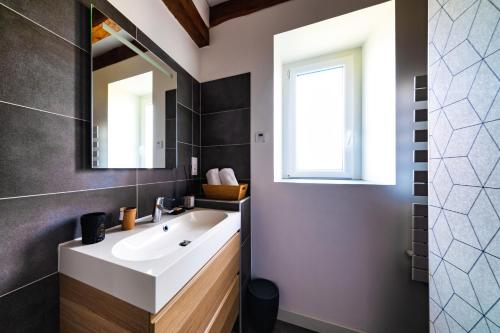 a bathroom with a white sink and a window at NUITS DE LOIRE -Entre Blois et Chambord in Vineuil