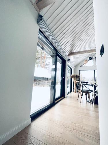 a living room with a large window and a table at Pärli puhkemaja / Pearl riverside house in Pudisoo