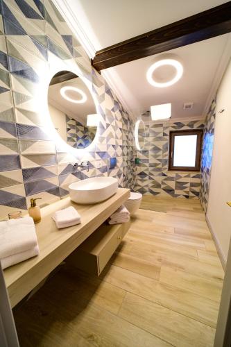 a bathroom with two sinks and a mirror at First Apartments in Focşani